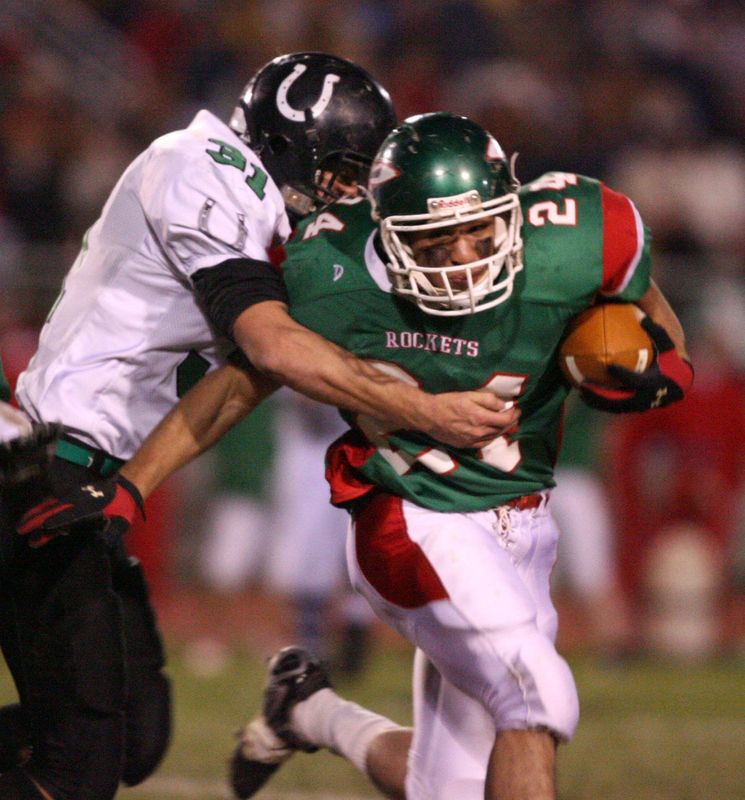 Oak Harbor's Aaron McCune carries the ball.