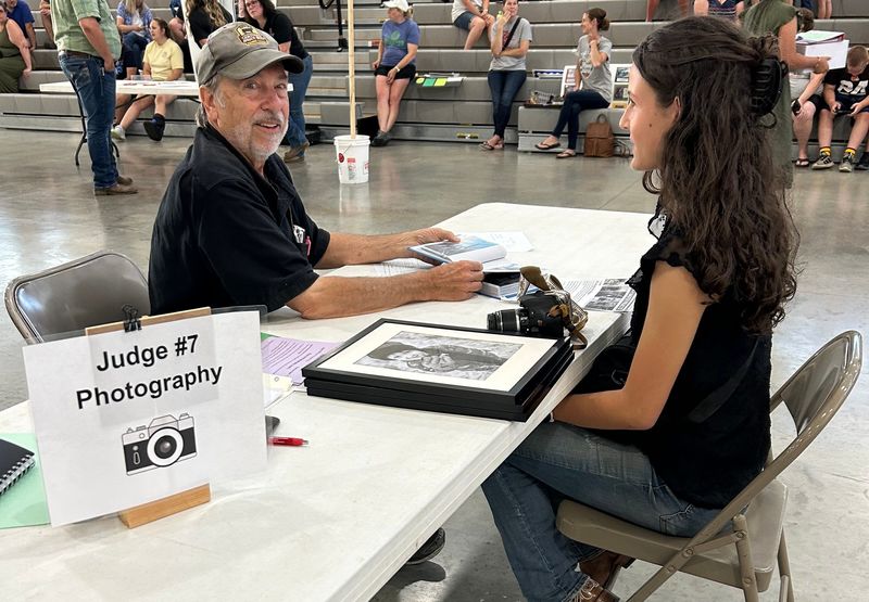 Mike Schenk, Daily Record photographer, judges a Photography Master 4-H project submitted by Maryn Erdman. Top project winners and Ohio State Fair representatives were recognized at the Style Revue and Awards program.