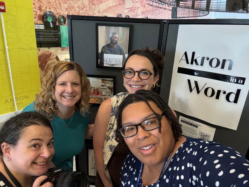 From left, Beacon Journal photojournalist Lisa Scalfaro, Executive Editor Cheryl Powell, Opinion and Community Engagement Editor Theresa Bennett and reporter Tawney Beans pose with the Akron in a Word display after assembling the exhibit at the Akron History Center.