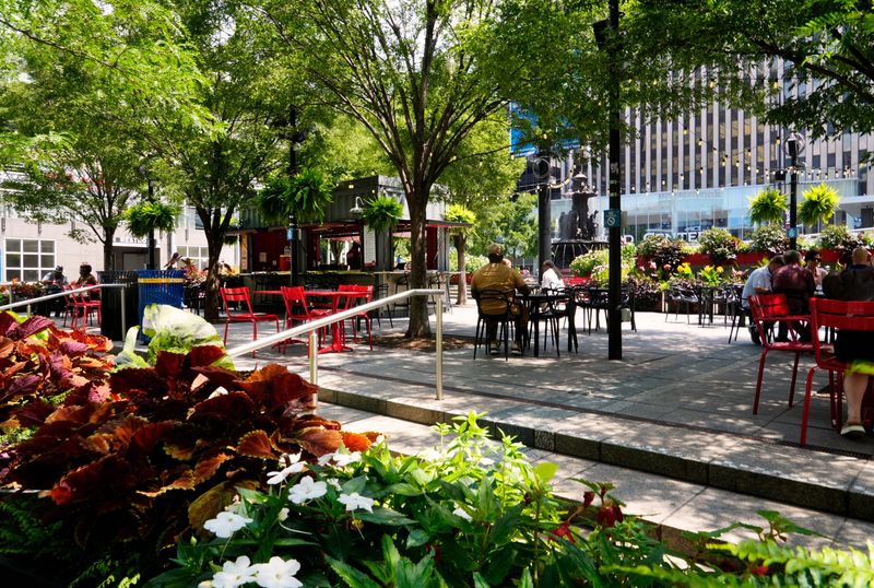 People find shade at the Container Bar on Fountain Square, located in downtown Cincinnati at 5th and Vine Street, July 24, 2025.