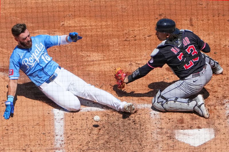 Cleveland Guardians catcher Bo Naylor (23) can’t make the tag as Kansas City Royals baserunner John Rave (16) scores on July 27, 2025, in Kansas City, Missouri.