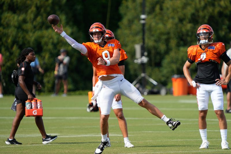 Bengals continue training camp Monday July 28, 2025. Players and coaches ran drills outside on the practice lawn until rain moved the camp to the Bengals' inside practice facility. Bengals Joe Burrow (9) winds up a throw.