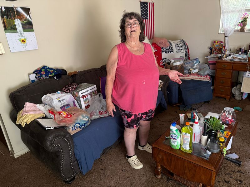Pamela Echard, 70, stands in her flooded apartment in Lancaster, Ohio on July 28, 2025.
