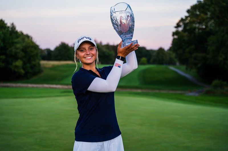 New Albany's Mia Hammond holds up the championship trophy after winning the Epson Tour’s Greater Toledo Classic by one shot.