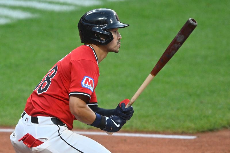 Jul 29, 2025; Cleveland, Ohio, USA; Cleveland Guardians left fielder Steven Kwan (38) hits an RBI single in the fifth inning against the Colorado Rockies at Progressive Field. Mandatory Credit: David Richard-Imagn Images