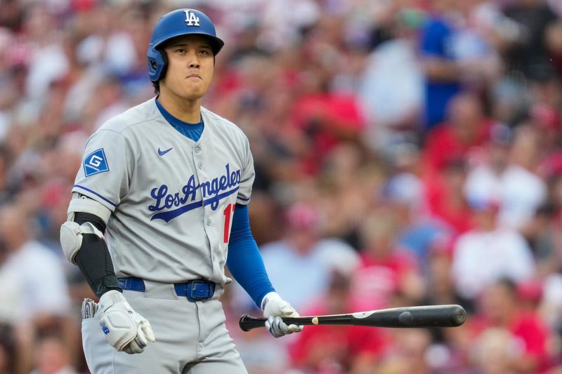 Shohei Ohtani returns to the dugout after striking out against Reds starters Nick Lodolo July 29. Ohtani struck out all three times he faced Lodolo.