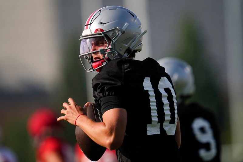 Ohio State Buckeyes quarterback Julian Sayin (10) takes a snap during football training camp at the Woody Hayes Athletic Center on Aug. 1, 2025.