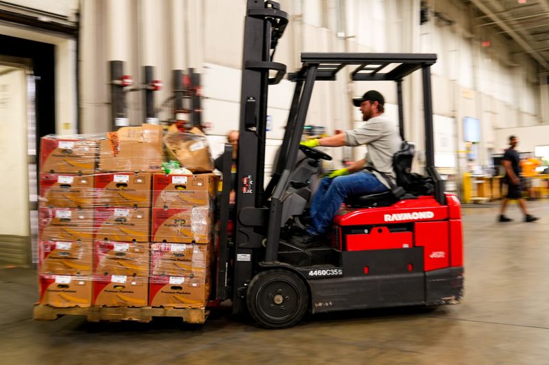 An employees transports produce at the Mid-Ohio Food Collective on Tuesday, July 29, 2025 in Grove City, Ohio.