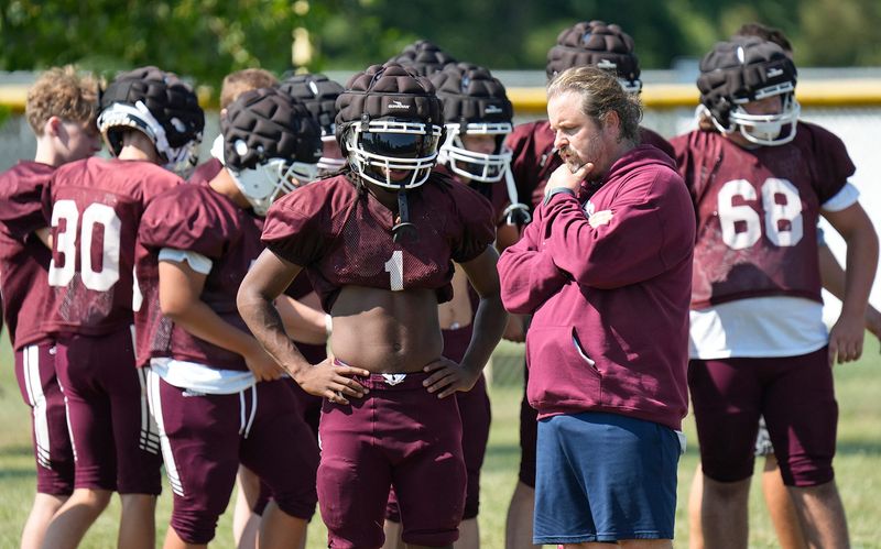 Keyshawn Anderson listens to head coach Nathan Brode during football practice at Waterloo High School in Atwater, Ohio on Friday Aug. 1, 2025.
