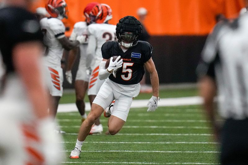 Cincinnati Bengals wide receiver Charlie Jones (15) runs with a catch during a preseason training camp practice in downtown Cincinnati on Thursday, July 31, 2025.