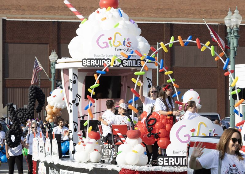 The Gigi’s Playhouse float moves down the street during the 2025 Pro Football Hall of Fame Enshrinement Festival Grand Parade in Canton.