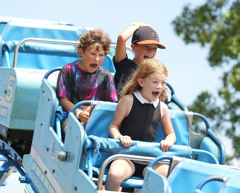 Landrie Hurd, 7, along with Ryker Hurd, 8, left, and Jackson Lockwood, 9, head down a hill on the Little Dipper at Sluggers & Putters Amusement Park in Canal Fulton.