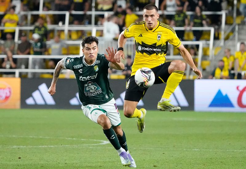 Columbus Crew defender Malte Amundsen (18) kicks the ball in front of Club Leon forward Ettson Ayon (14) during the second half of the Leagues Cup soccer match at Lower.com Field in Columbus on Aug. 5, 2025.