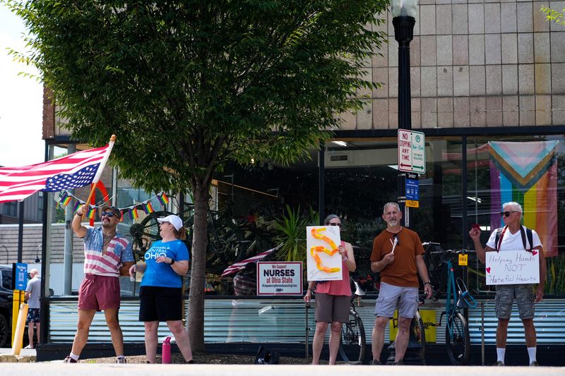 People participate in the Hands Along High Street protest in the Short North on Saturday, Aug. 9, 2025 in Columbus, Ohio.