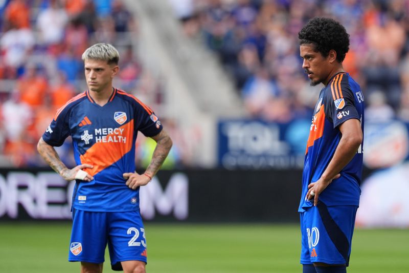 Aug 10, 2025; Cincinnati, Ohio, USA; FC Cincinnati midfielder Evander (10) and midfielder Luca Orellano (23) looks on during the first half against Charlotte FC at TQL Stadium.