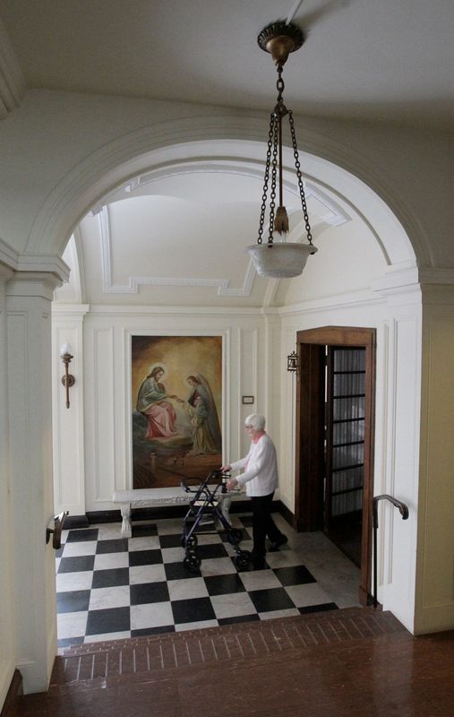 Sister Lin Howley, 90, walks the convent corridor at Our Lady of the Elms in 2013 in Akron.