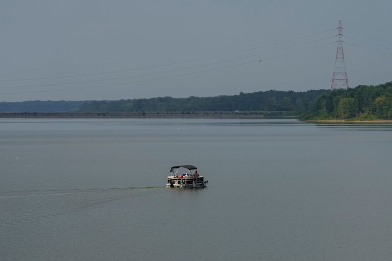 A pontoon rides over Hoover Reseroir on Aug. 15, 2025. Columbus is planning to annex land around Hoover Reservoir from townships in Franklin and Delaware counties. The reservoir and surrounding parkland covers more than 2,000 acres.