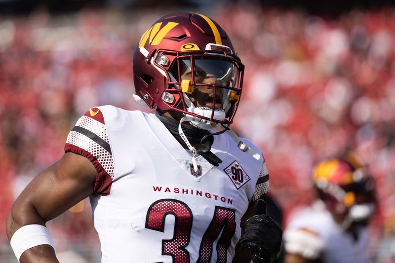 Dec 24, 2022; Santa Clara, California, USA; Washington Commanders cornerback Christian Holmes (34) runs onto the field before the start of the first quarter against the San Francisco 49ers at Levi's Stadium. Mandatory Credit: Stan Szeto-USA TODAY Sports