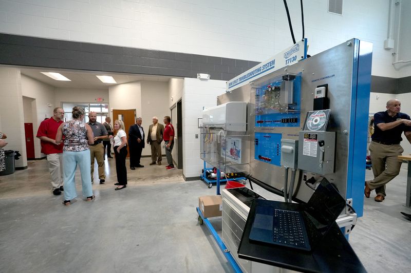 Visitors explore the new heating, ventilation, air conditioning and refrigeration facility at Canton South High School. The new program and facility was funded by a $4.2 million state grant. The program is part of the South Stark Career Academy that serves juniors and seniors at Canton South, East Canton, Perry and Sandy Valley high schools.