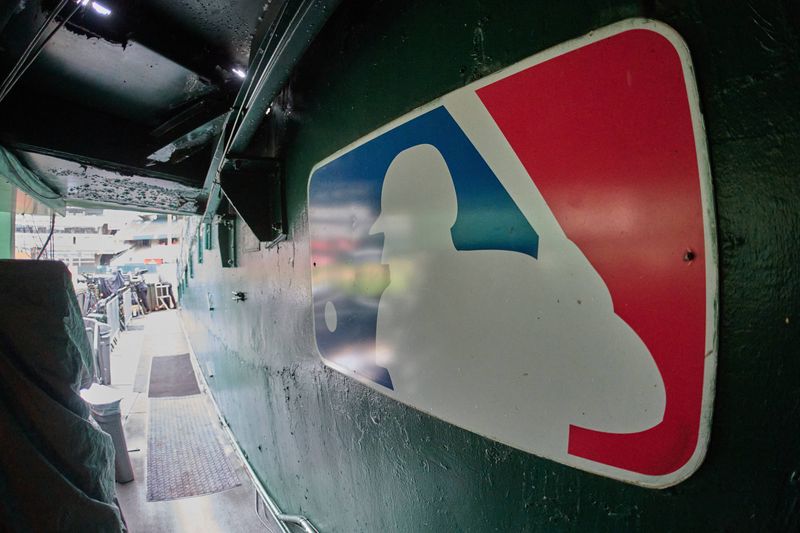 Aug 24, 2024; Oakland, California, USA; The major league baseball logo is seen on signage near the player's entrance to the field at Oakland-Alameda County Coliseum before the game between the Oakland Athletics and the Milwaukee Brewers. Mandatory Credit: Robert Edwards-USA TODAY Sports