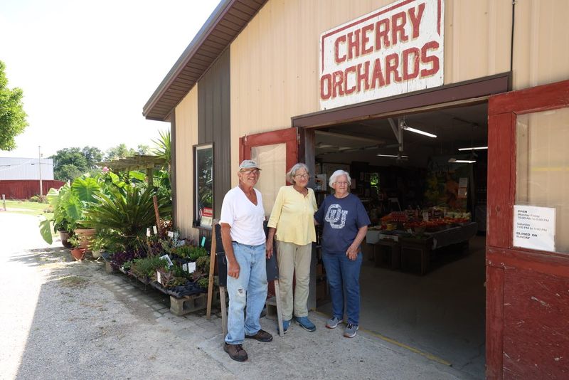 Neil and Fayebelle Cherry stand outside their shop where they sell produce along with their friend Linda Lunn, right. The Cherrys own and operate Cherry Orchards outside Crooksville.
