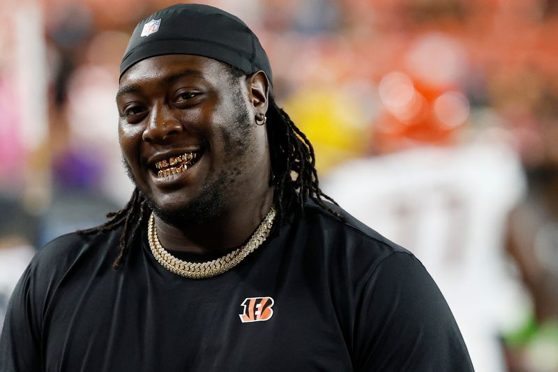Aug 18, 2025; Landover, Maryland, USA; Cincinnati Bengals defensive tackle T.J. Slaton Jr. smiles on the bench against the Washington Commanders during the fourth quarter at Northwest Stadium. Mandatory Credit: Geoff Burke-Imagn Images