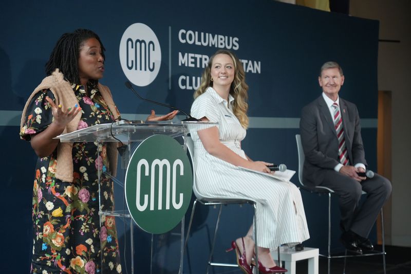 Columbus Metropolitan Club President and CEO Sophia Fifner (left) welcomes moderator Sheridan Hendrix, higher education reporter with The Columbus Dispatch, and Ohio State University President Ted Carter at a panel discussion the club hosted Aug 20, 2025, at the National Veterans Memorial and Museum in Columbus.