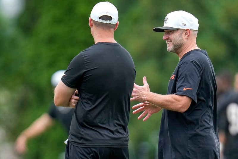 Cincinnati Bengals head coach Zac Taylor and director of player personnel Duke Tobin talk during practice at the Paycor Stadium practice field in downtown Cincinnati on Wednesday, Aug. 20, 2025.