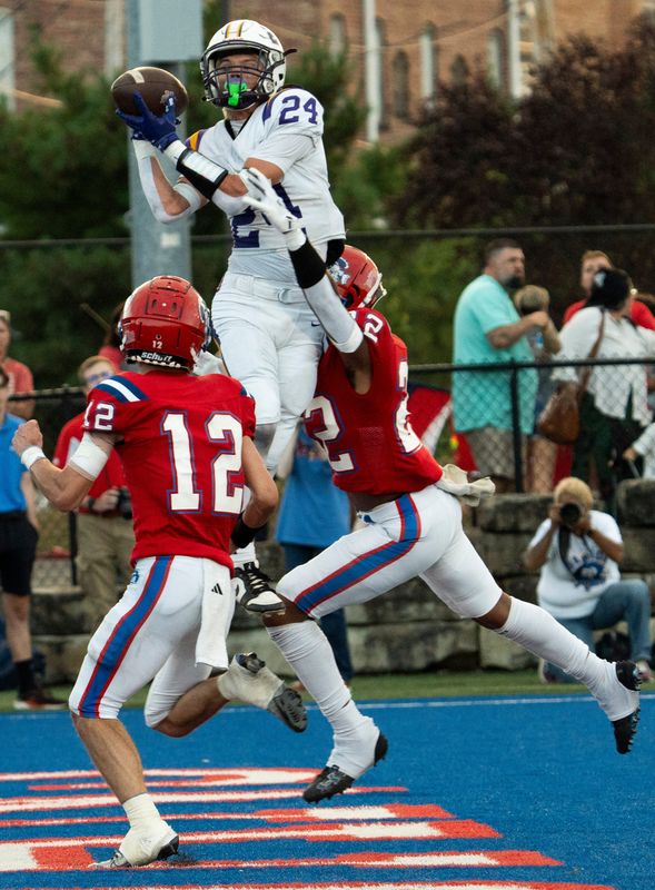 Unioto’s Jaxon Zickafoose (24) jumps above the Portsmouth defense and hauls in the pass scoring a touchdown in varsity football action at Portsmouth High School on August 21, 2025, in Portsmouth, Ohio.