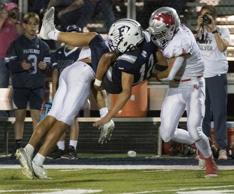 Fairless’s Jack Kirby is taken down by Sandy Valley’s Caleb Deubner (left) and Gino Tozzi (right) on Thursday, August 21, 2025. Bob Rossiter / Special To The Canton Repository