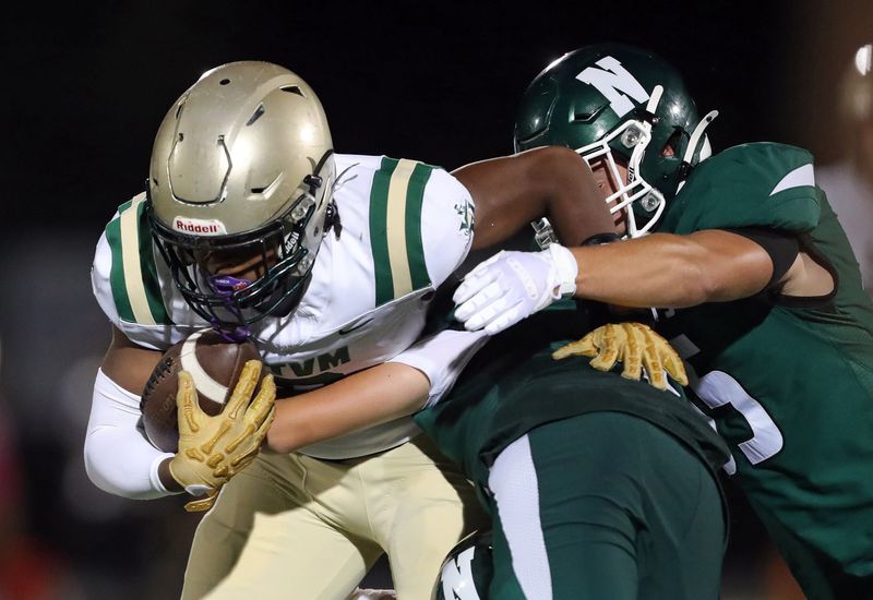 STVM wide receiver JaNeal Baker left, is brought down by a host of Nordonia defenders during the second half of a high school football game, Aug. 22, 2025, in Macedonia, Ohio.