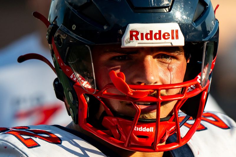 Indian Valley's Grady Kinsey meets with fellow captains from Green during the coin toss, Aug. 22, 2025.