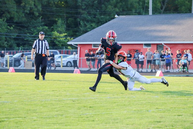 North Union's Griffin Osborne makes a tackle on Pleasant's Cole Bailey during a season opener at Pleasant Aug. 22, 2025.