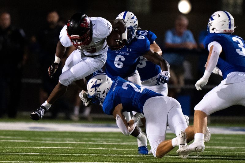 St. Xavier defensive back Brayden Reilly takes down Lakota West running back Kenyon Norman in the fourth quarter of the Bombers' 14-7 victory Aug. 22. Reilly also had an interception.