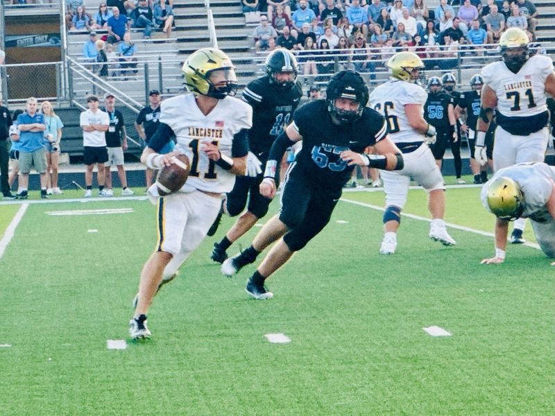 Lancaster senior quarterback Brody Burke looks for running room against Hilliard Darby on Friday, Aug. 22, 2025. The Gales pulled out a 21-20 victory.