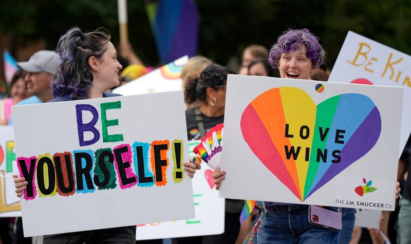Workers from J.M. Smucker Co. march in the 2025 Akron Pride parade, Aug. 23, 2025, in Akron, Ohio.