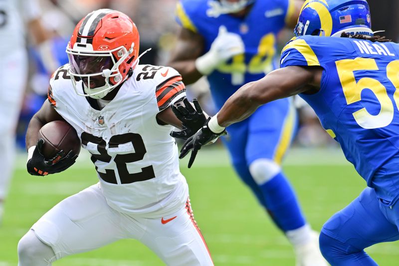 Cleveland Browns running back Dylan Sampson (22) runs as Los Angeles Rams linebacker Elias Neal closes in Aug. 23, 2025, Cleveland.
