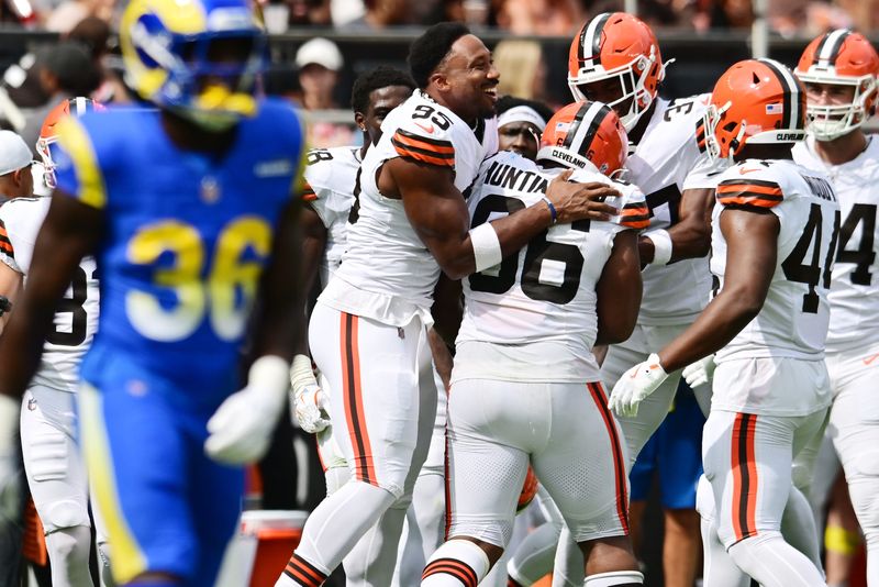 Aug 23, 2025; Cleveland, Ohio, USA; Cleveland Browns defensive end Myles Garrett (95) celebrates with defensive end Adin Huntington (66) after Huntington sacked Los Angeles Rams quarterback Dresser Winn (not pictured) during the second half at Huntington Bank Field. Mandatory Credit: Ken Blaze-Imagn Images