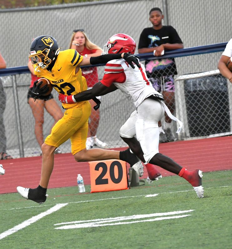 Jake Schuckman (22) powers into the red zone for Moeller at the Princeton vs. Moeller King of the Block rivalry football game, Aug. 23, 2025.