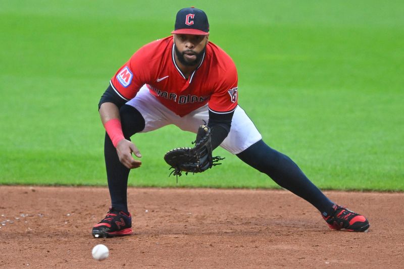 Aug 25, 2025; Cleveland, Ohio, USA; Cleveland Guardians first baseman Carlos Santana (41) fields a ground ball in the third inning against the Tampa Bay Rays at Progressive Field. Mandatory Credit: David Richard-Imagn Images