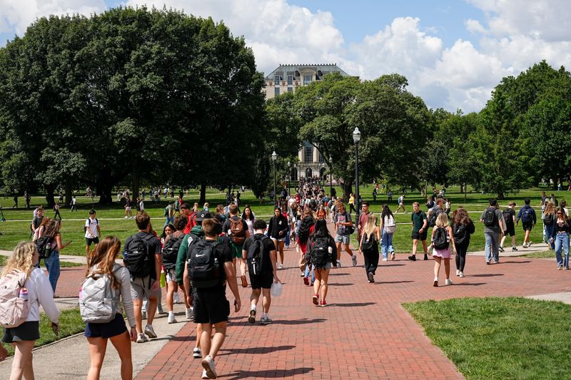 Students walk across the Oval on Ohio State's campus on Aug. 26, 2025, the first day of class for the fall semester.