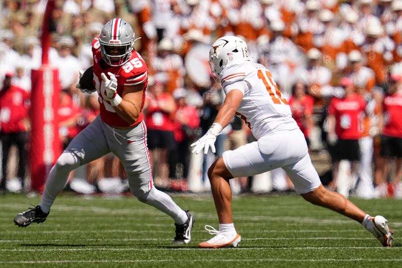Ohio State Buckeyes tight end Bennett Christian (85) runs past Texas Longhorns linebacker Liona Lefau (18) during the first half of the NCAA football game at Ohio Stadium on Aug. 30, 2025.