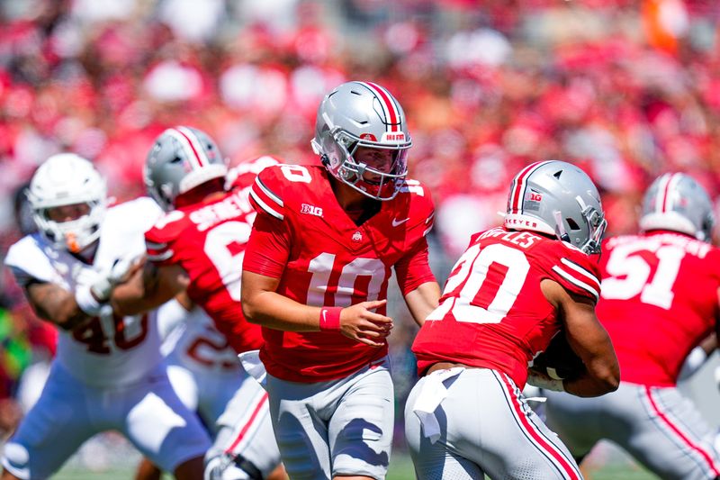 Ohio State quarterback Julian Sayin hands off to running back James Peoples in the Buckeyes' 14-7 win over Texas.
