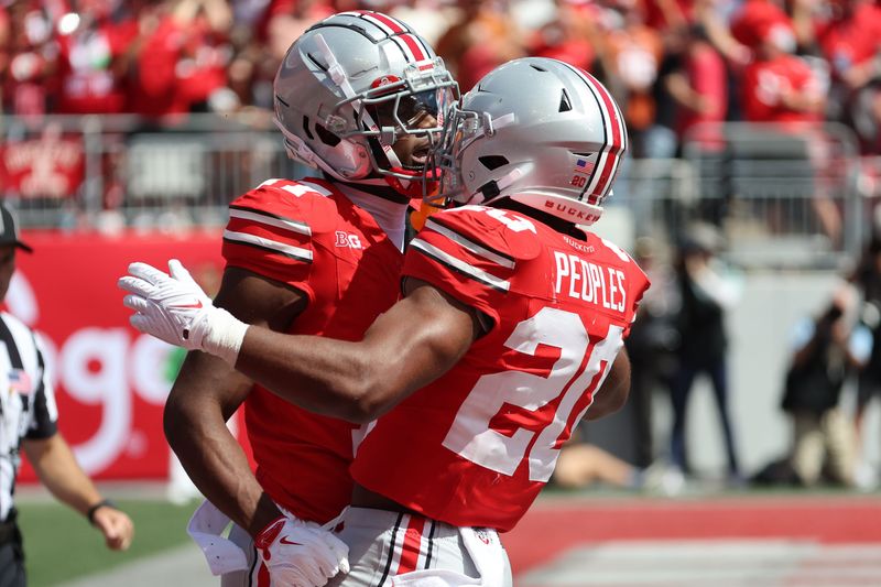 Aug 30, 2025; Columbus, Ohio, USA; Ohio State Buckeyes wide receiver Carnell Tate (17) reacts with running back James Peoples (20) in the second half at Ohio Stadium. Mandatory Credit: Joseph Maiorana-Imagn Images