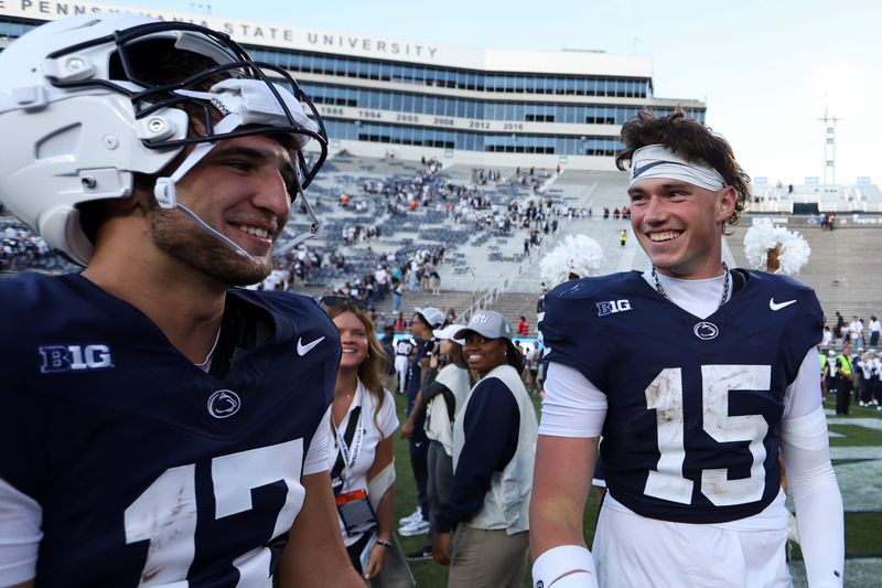 Aug 30, 2025; University Park, Pennsylvania, USA; Penn State Nittany Lions quarterbacks Ethan Grunkemeyer (17) and Drew Allar (15) share a moment together following the competition of the game against the Nevada Wolf Pack at Beaver Stadium. Penn State defeated Nevada 46-9. Mandatory Credit: Matthew O'Haren-Imagn Images