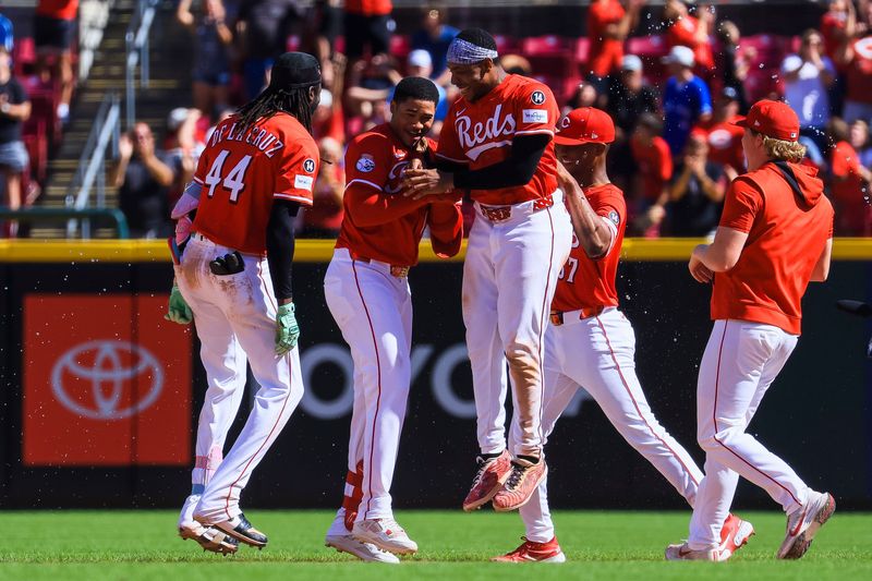 The Reds celebrate Noelvi Marte's (second from left) game-winning hit in the ninth inning on Labor Day. The Reds kept pace, but gained no ground on the New York Mets, who beat Detroit 10-8.