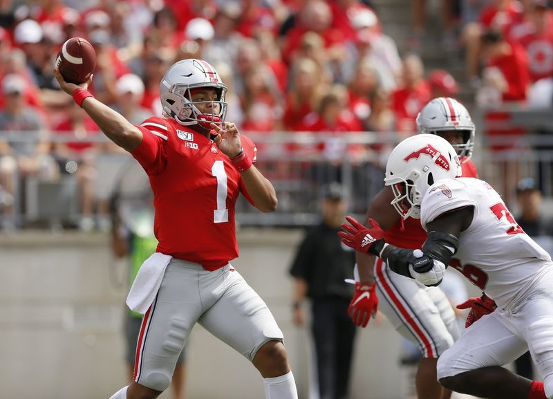 Ohio State Buckeyes quarterback Justin Fields (1) throws a pass over Florida Atlantic Owls linebacker Akileis Leroy (36) during the second quarter of the NCAA football game at Ohio Stadium in Columbus on Saturday, Aug. 31, 2019.