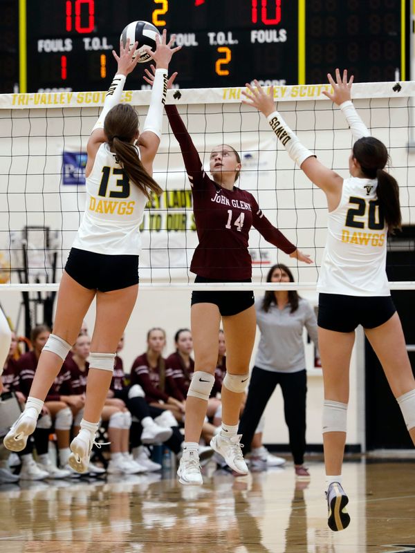 Blair Briggs tries to get the ball past Reagan Lamonica, left, during John Glenn's 20-25, 25-23, 23-25, 14-25 loss against Tri-Valley on Thursday, Sept. 4, 2025, in Dresden, Ohio.