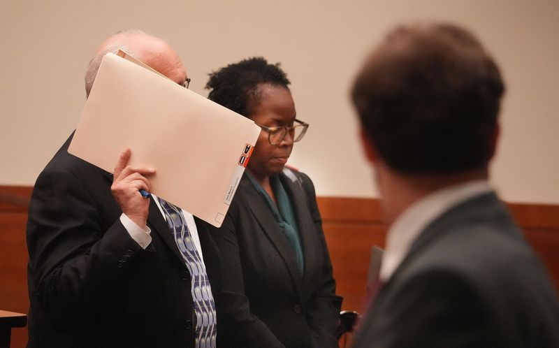 Marcia Davis, an assistant principal in the Columbus City School system, appears on Sept. 5, 2025 for an arraignment on charges she paid off women accusing her husband of rape. Holding the folder is her attorney, Michael Moran.
