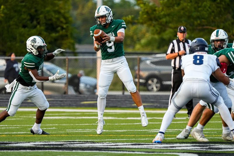 Ryan Ziegler (9) of the Aurora Greenmen grabs a high snap for a handoff during a game against Twinsburg, Sept. 5, 2025, in Aurora, Ohio.